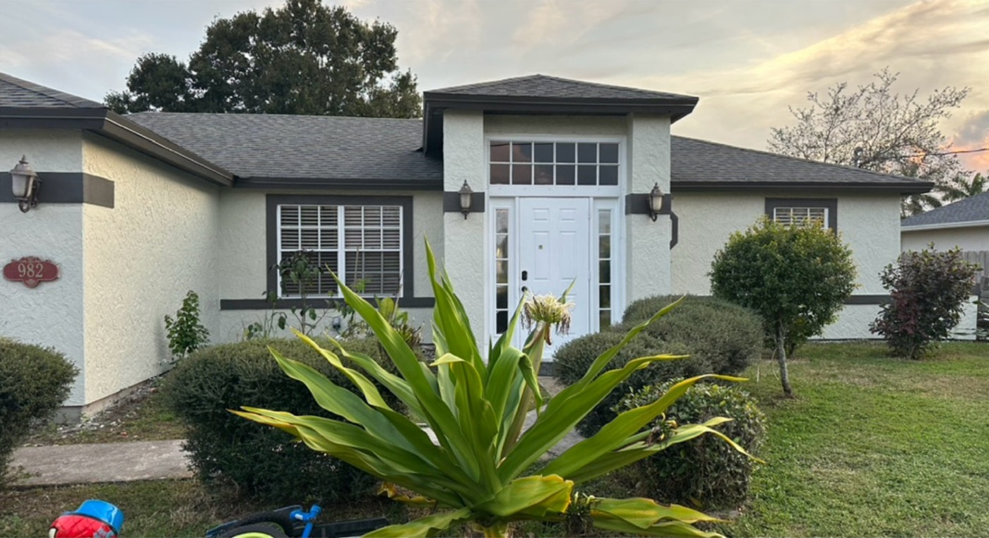 Repainted single-story home with light walls and contrasting dark trim