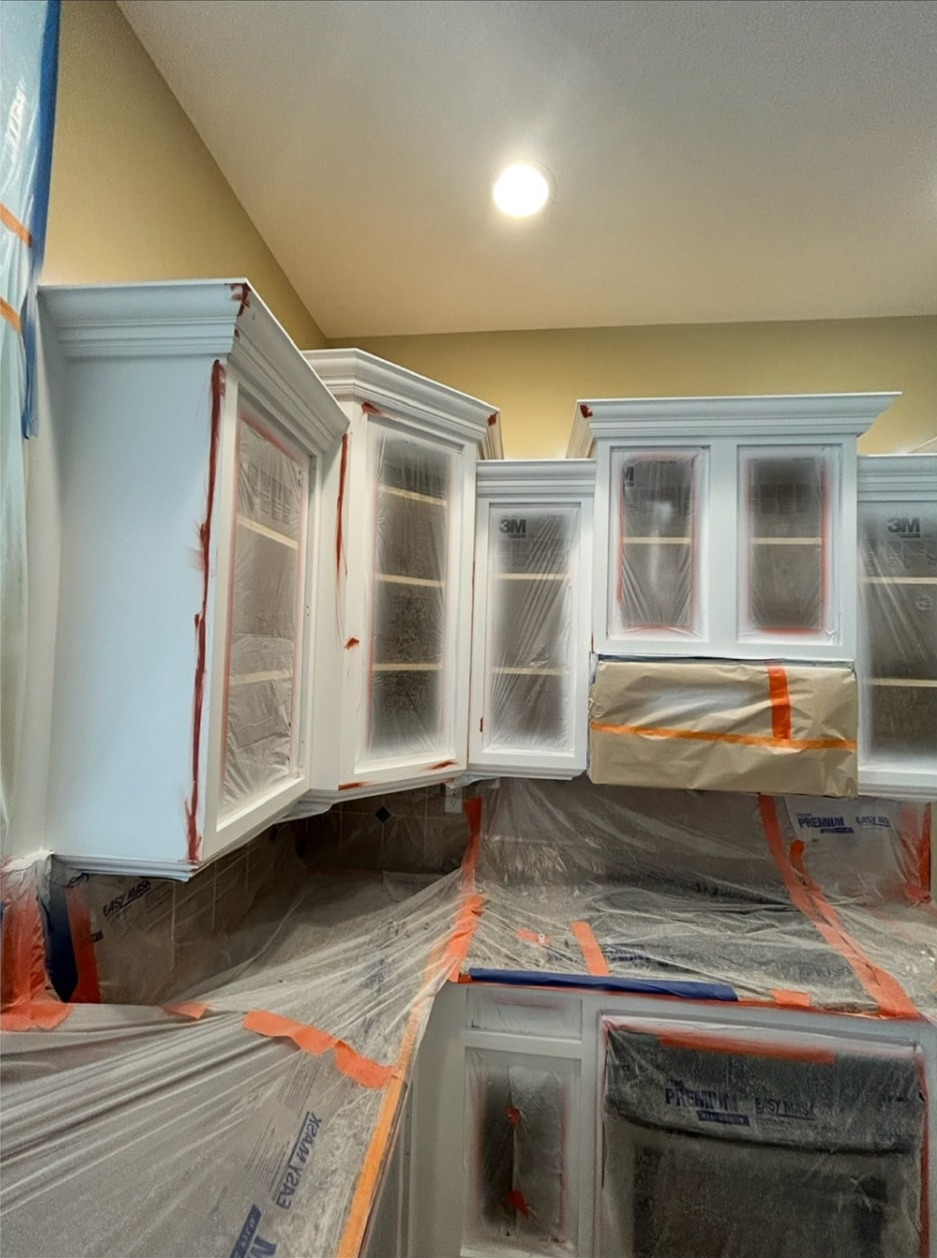 Kitchen cabinets masked and prepared for painting
