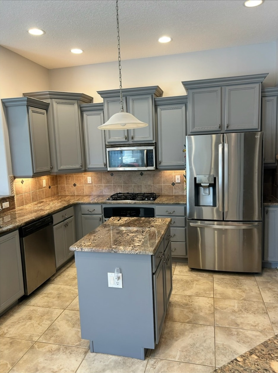 Finished gray kitchen cabinets with stainless-steel appliances